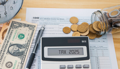 The number 2025 on the calculator and euro banknotes, taxes, tax burden, savings and New Year.