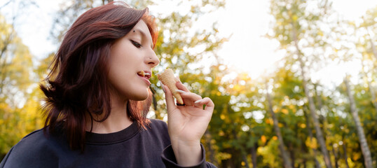 With a look of blissful contentment, a youthful figure savors the cool, sweet taste of ice cream nestled in a crisp waffle cup.