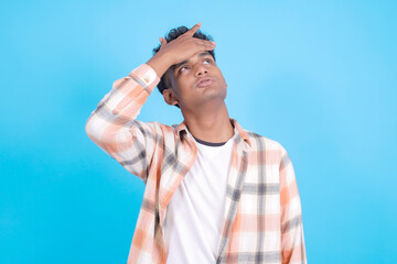 Unhappy Young Asian Man Wear Casual Clothes Disappointed Isolated on Blue Background