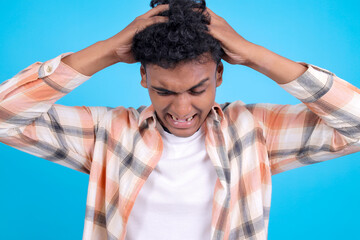 Dizzy Young Asian Man Confused With Touching his Head Clothes Isolated on Blue Background