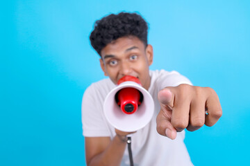 Young Indian Man Yelling on Megaphone Announces Discounts Sale Hurry up While Pointing at Camera