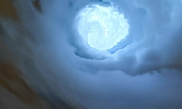 The clouds swirl into vortices and create a tunnel