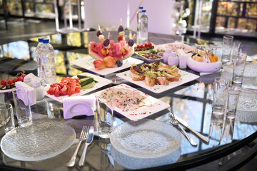 An Elegant Dining Table beautifully arranged with Gourmet Dishes and Refreshing Beverages