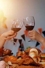 friendship, holiday and people concept - group of happy smiling friends in halloween costumes of vampire, devil, witch and cheetah at home party