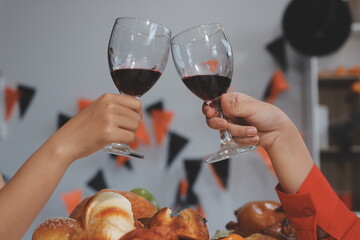 friendship, holiday and people concept - group of happy smiling friends in halloween costumes of vampire, devil, witch and cheetah at home party