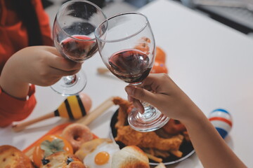 friendship, holiday and people concept - group of happy smiling friends in halloween costumes of vampire, devil, witch and cheetah at home party