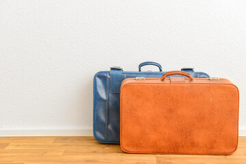 Blue and brown retro leather suitcases  on floor in room