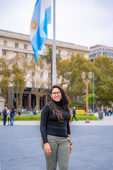 A young Latina woman poses in front of the historic Casa Rosada in Buenos Aires, Argentina,...