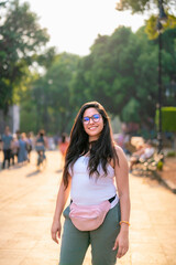 Naklejka premium Young Latina woman smiling and enjoying a sunny day while walking in Coyoacan, Mexico City, Mexico.