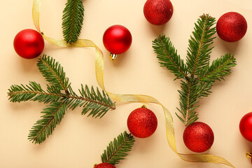 Composition with beautiful Christmas balls, ribbon and fir branches on color background