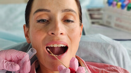 Taking a saliva buccal swab test probe sample for virus genetic drug laboratory analysis concept © Nadzeya