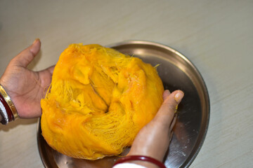 Ripe toddy palm fruit or palmyra palm on a woman hand isolated. Selective focus.