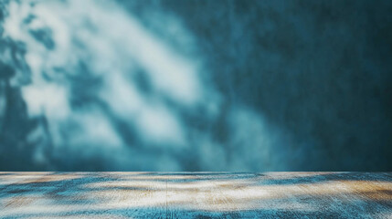 Obraz premium Abstract Blurry Shadows on Blue Wall and Wooden Surface. Blurry shadows cast on a textured blue wall with a light wooden surface, creating a serene abstract scene.