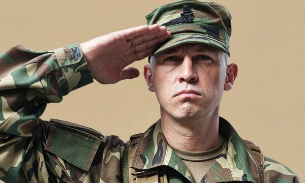 A male soldier in camouflage, saluting with a stern expression.