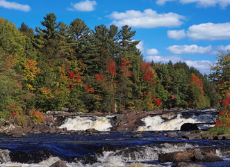 Wilson Falls, with autumn leaf color background in Saint Jerome, Quebec