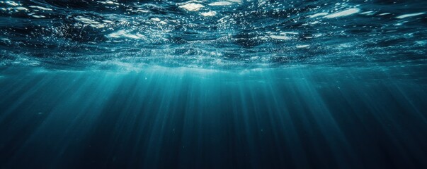 Underwater view of the dark blue ocean surface