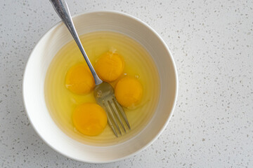 Egg yolks in white bowl ready to mix