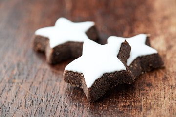 Christmas cookies (cinnamon stars) on dark background. Close up.