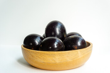 Grilled salted eggs on wooden bowl. Salted eggs are usually made from duck eggs fermented with ash and salt.