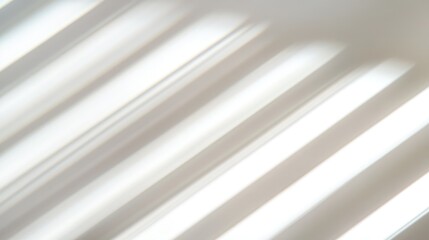 Obraz premium Shadows of blinds casting striped patterns on a white wall in a minimalist interior