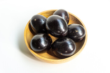 Grilled salted eggs on wooden bowl. Salted eggs are usually made from duck eggs fermented with ash and salt.