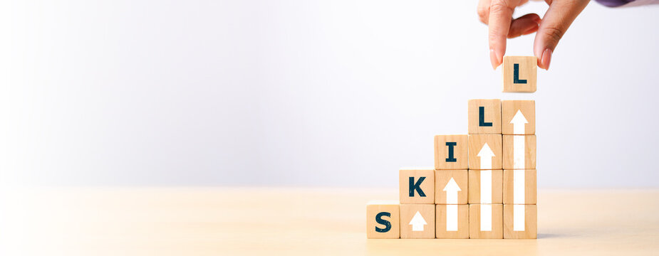 skills icon on wooden cube. Upskilling and personal development concept. Skill training, education, learning, ability. Upskilling, reskilling,