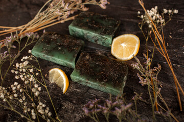 Handmade Green Soap With Lemon and Wildflowers on Rustic Wood