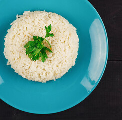 Plate of rice on a wooden table with garnish