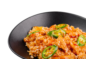 Spicy chicken and rice dish being served on black plate