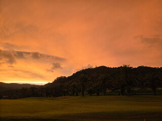 sunset in thailand with views of mountains and palm trees