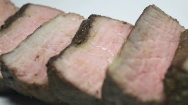 Grilled beef steak slices on white background