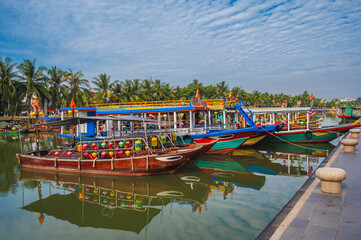 Traditional Vietnamese boats on Thu bon river in the old town in Hoi An in Vietnam in summer