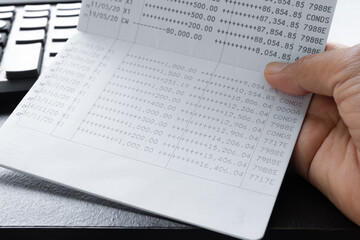 Bank account book statement balance number cash, hand holding data investment debt math in office,...