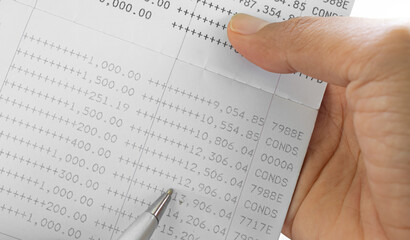 Obraz premium Bank account book statement balance number cash, hand holding data investment debt math in office, bill receipt and payment business credit card account, check paper financial loan tax concept.
