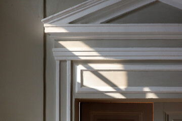 The white trim on the door is very ornate