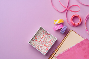 Crafting supplies on a purple background ready for creative projects