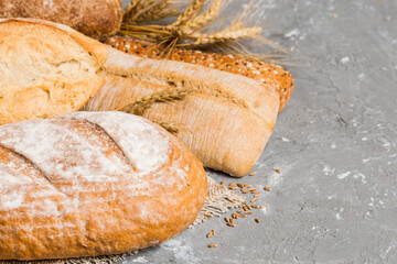Homemade natural breads. Different kinds of fresh bread as background, perspective view with copy space