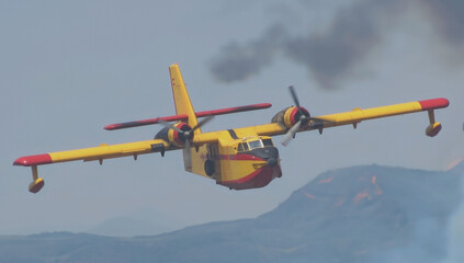 firefighting seaplane in action flying mountains fire smoke