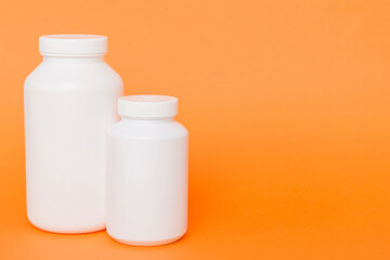 supplement pills with medicine bottle health care and medical top view. Vitamin tablets. Top view mockup bottle for pills and vitamins with green leaves, natural organic bio supplement, copy space