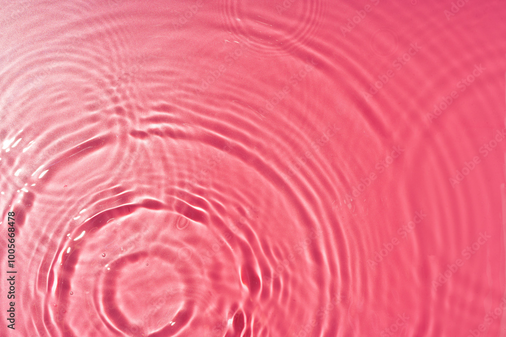 Poster ripples of light and color in a pink water surface reflecting mesmerizing patterns at midday