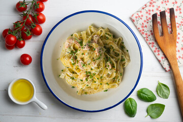 Fresh Italian pasta with salmon and cream. Top view table with decorations.