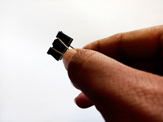 Close up photo Hand Holding Binder Paper Clips Isolated White Background