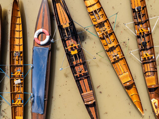 The kayaks are tied together side by side on the water.
