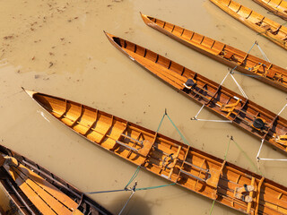 The kayaks are tied together side by side on the water.