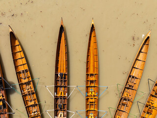 The kayaks are tied together side by side on the water.