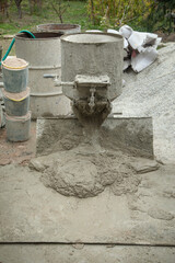 Concrete with cement mixer machine at construction site.