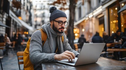 Nomadic worker balancing tasks and travel while sitting at a cafe in a bustling city