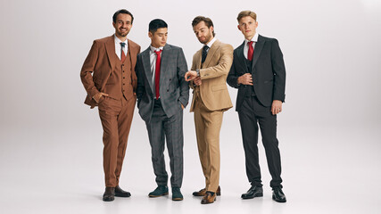 Full-length photo of group of male team dressed classy formal suits against white studio background. Leadership. Concept of business, male fashion, style, beauty, aesthetic. Ad