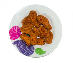 Some crispy nuggets neatly arranged on a plate in a solid white background