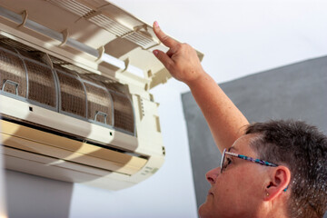 domestic problem with the air conditioner, technician checks the appliance
